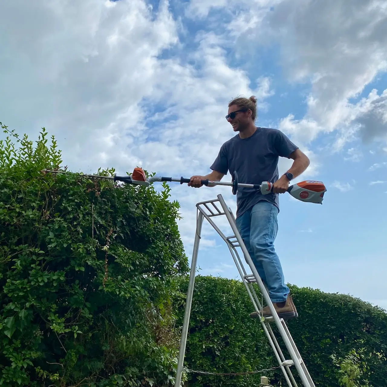 Levi hedge trimming a large hedge